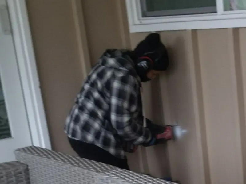 Professional electrician installing an exterior outlet in Boone